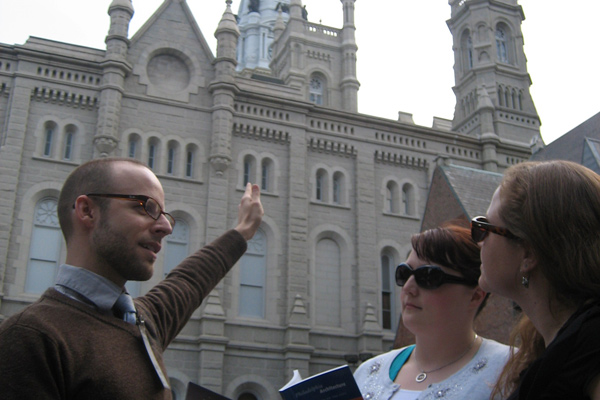 The tour passes by City Hall to discuss its remarkable architectural design.
